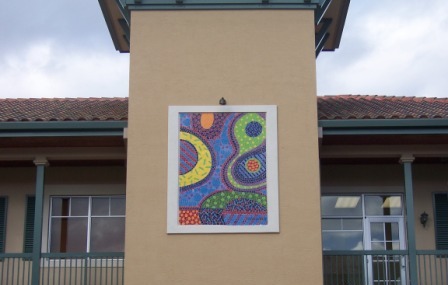 Artist's conceptual painting of bacteria in frame on side of building